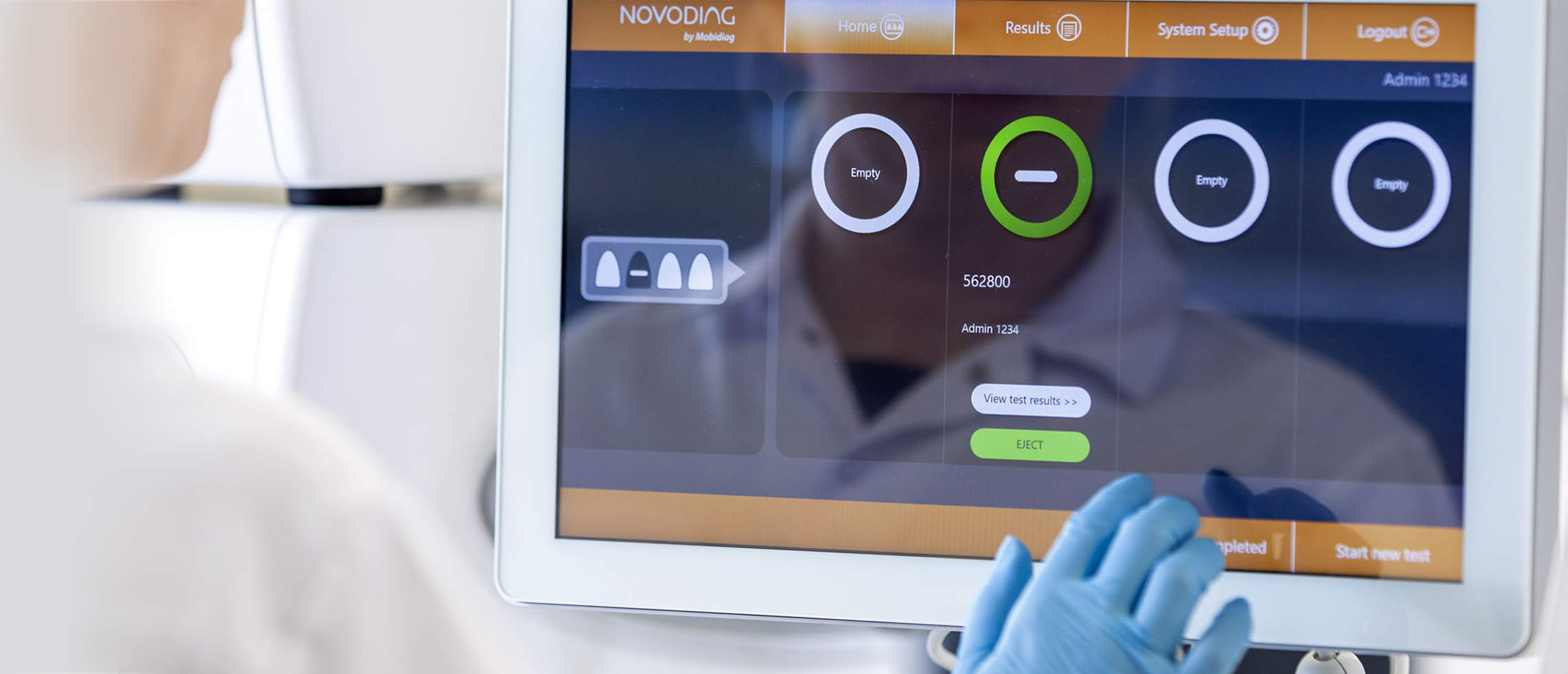 Technician interacts with display screen in a lab setting.