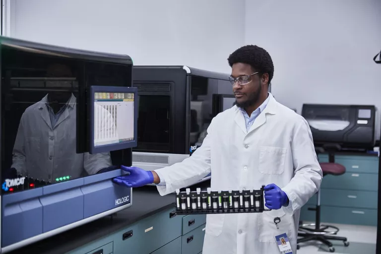 Lab technician using Hologic equipment