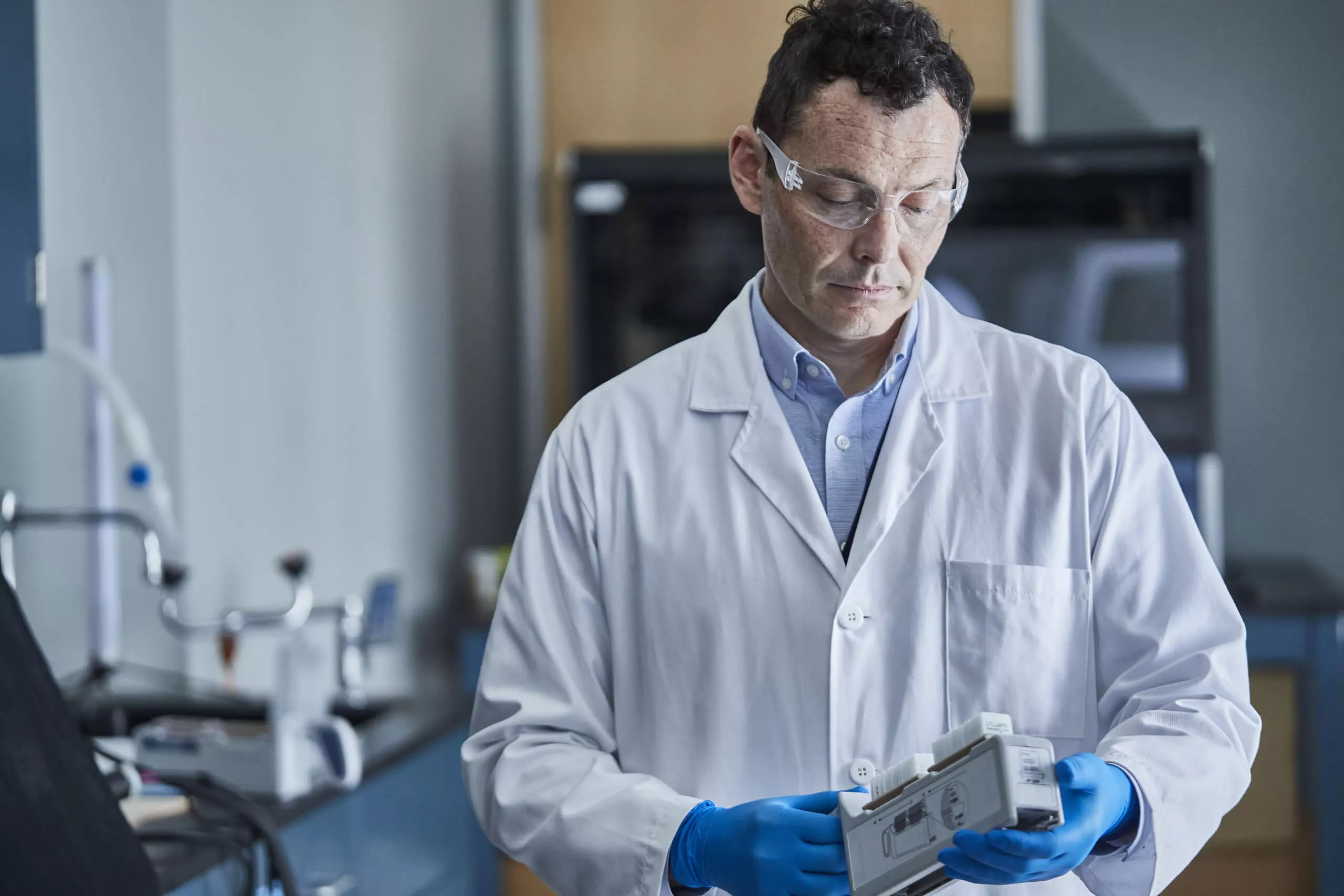 Technician looking at specimen in lab