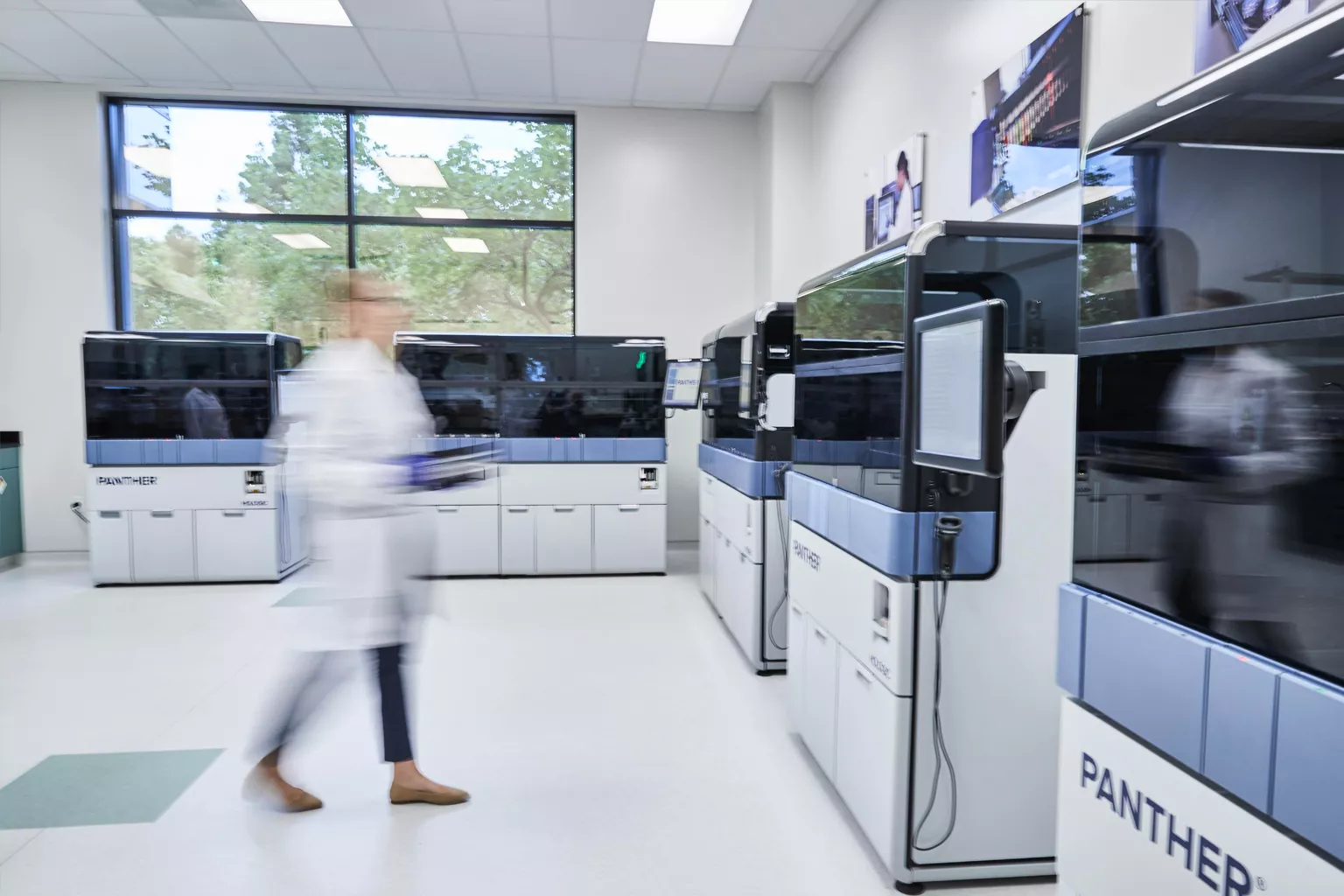 Lab technician walking through lab setting.