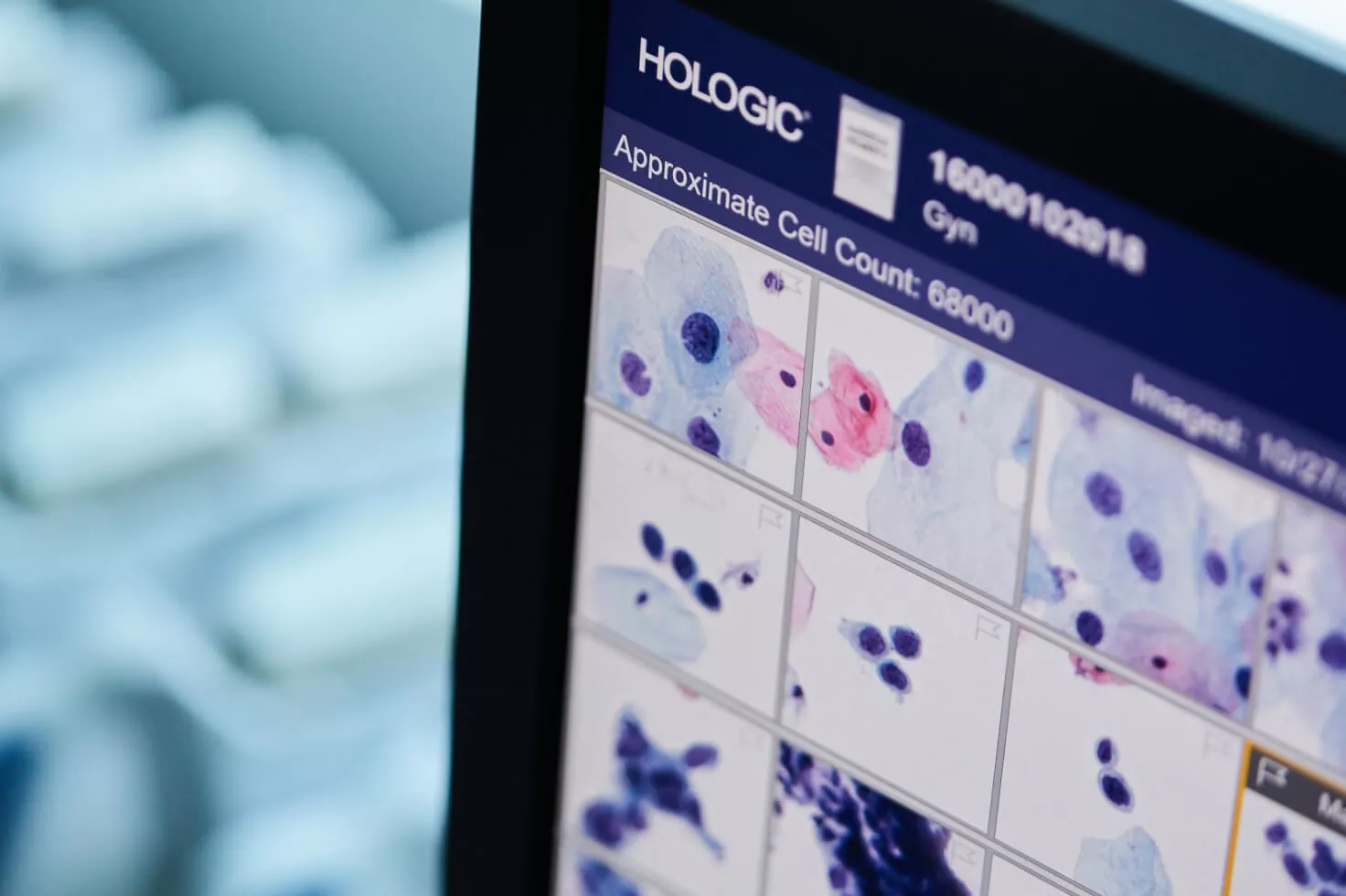 Close up of monitor screen filled with image scans with Hologic logo at the corner