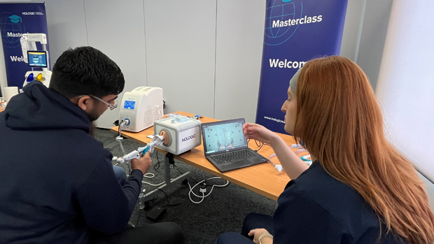 Medical professional training person on Hologic's hysteroscopy devices